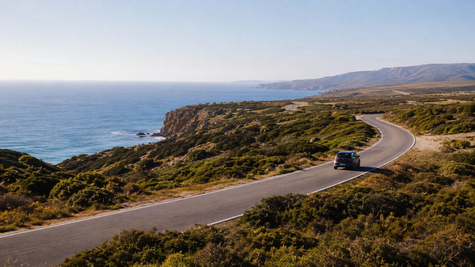 Coastal road winding along the Algarve cliffs, southern Portugal